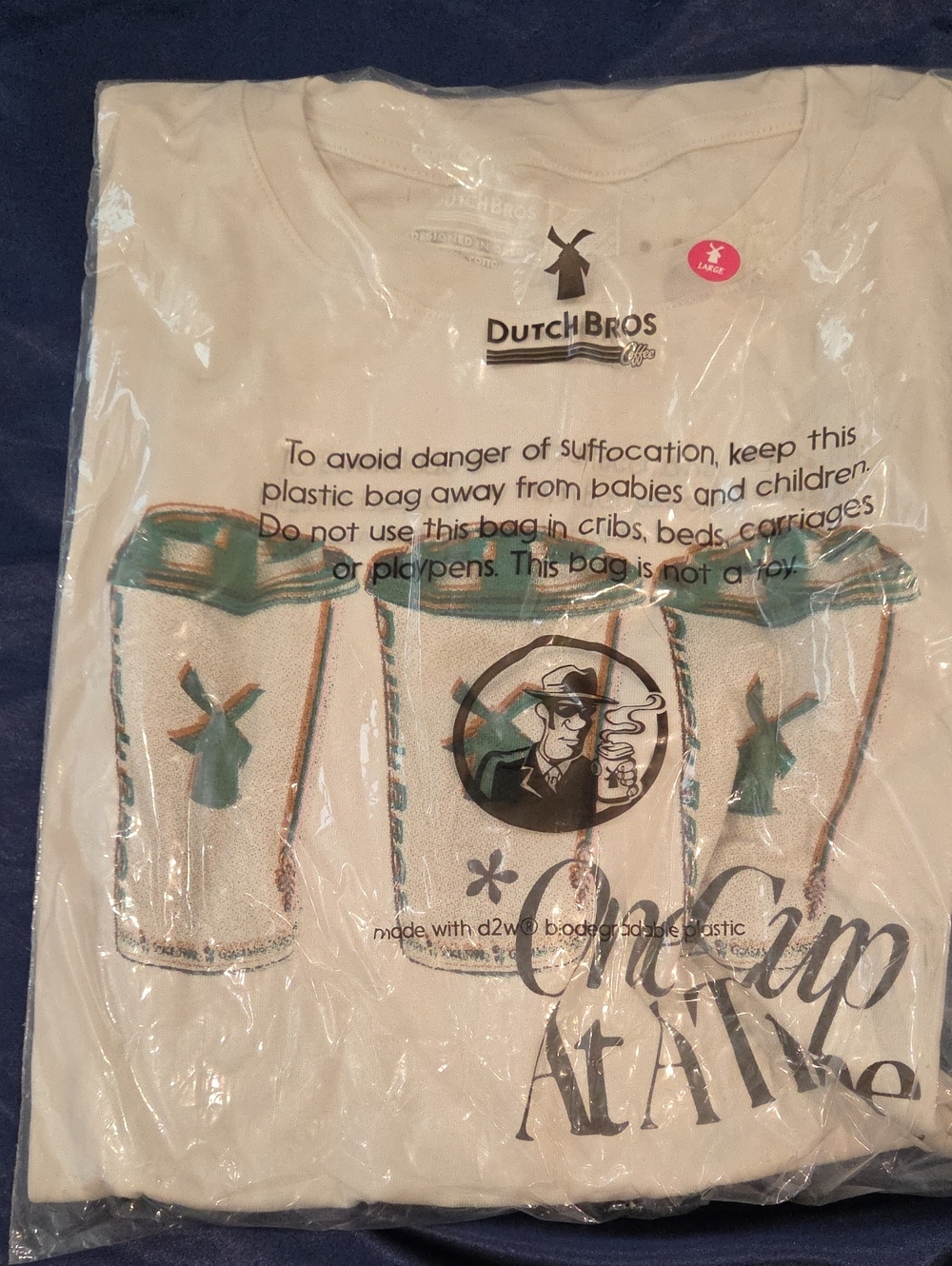 Dutch Bros Cream Kids Graphic Tee with Teal and Black Accents